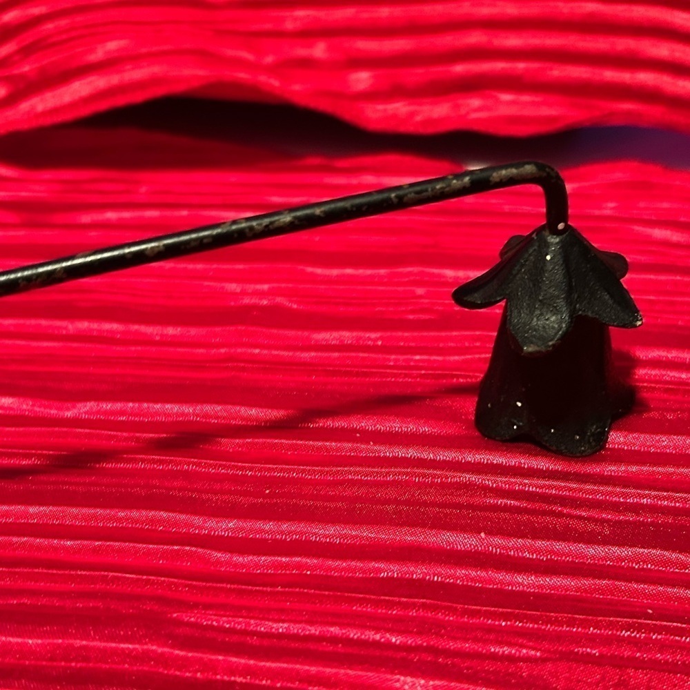 Vintage 13 1/2” black metal candle snuffer with tulip lie shape on end and swirl